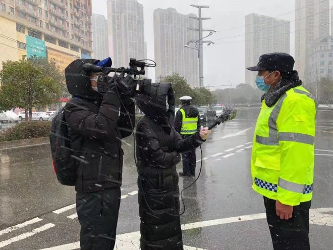 孝感市融媒體中心楊亞玲（風雪中，采訪疫情期間重返一線的退休警察）_副本.jpg.jpg
